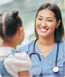 Female medical assistant smiling at a child